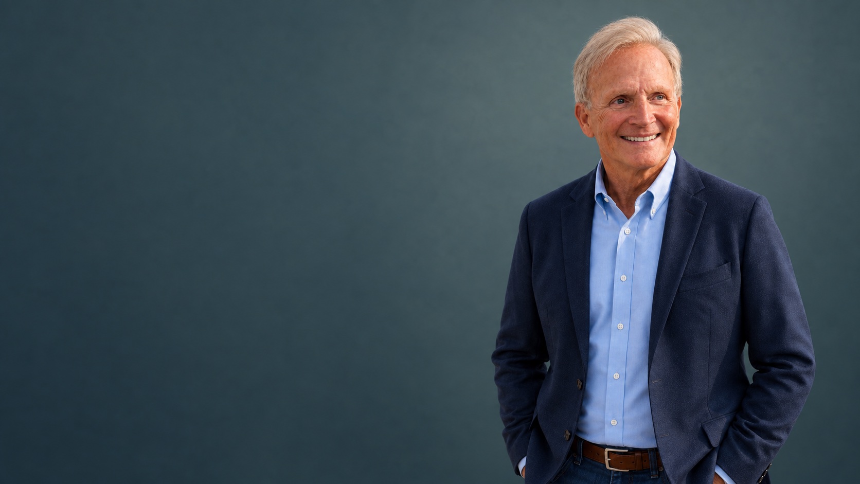 Dr. F. Blake Ambridge, smiling, in a navy blazer and light blue shirt